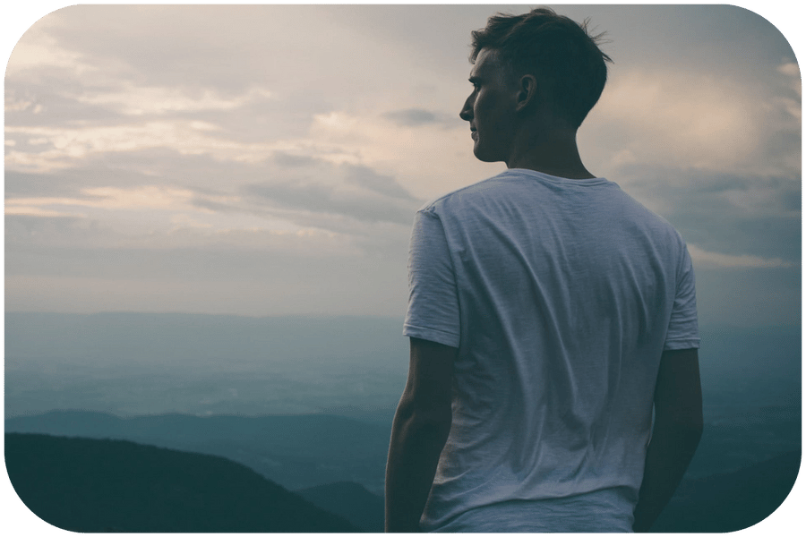 Man looking over horizon deep in thought Man looking over horizon deep in thought