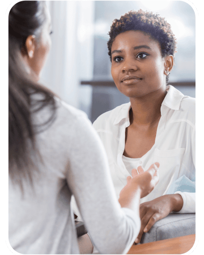 Working with a therapist, client talking with a therapist looking relieved. Working with a therapist, client talking with a therapist looking relieved.