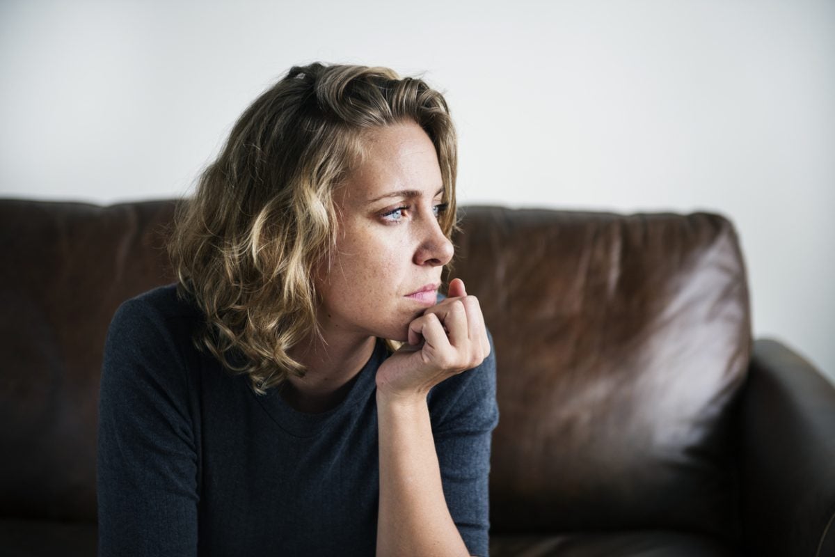 Depressed woman in deep thought; thinking whether she'll change her therapist