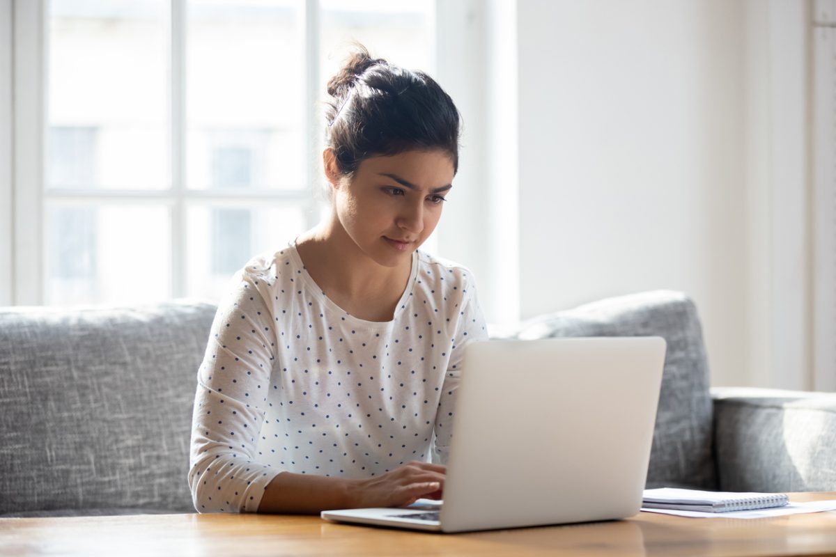 Woman at home using a laptop for research - finding the right therapist in Toronto
