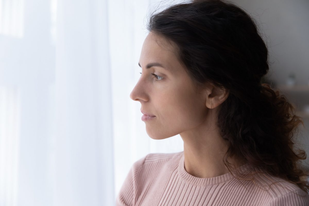 Close-up picture of a woman in deep thought about cbt and mental health
